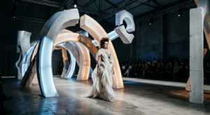 A high-fashion editorial shot capturing a conceptual haute couture runway installation featuring sur