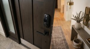 A professional, high-angle editorial shot of a sleek, modern biometric smart lock installed on a sty